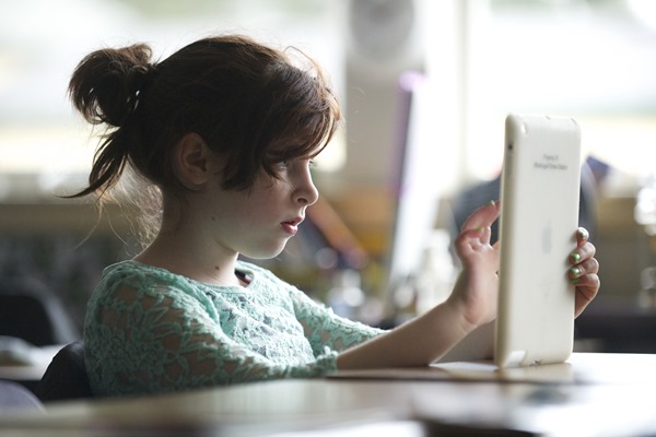 Tessa Haas, 10, a fifth grader in teacher Erin Hayes class at Hathaway Elementary School in Washougal, uses an iPad for her daily work, Tuesday, January 28, 2014. (Steven Lane/The Columbian)